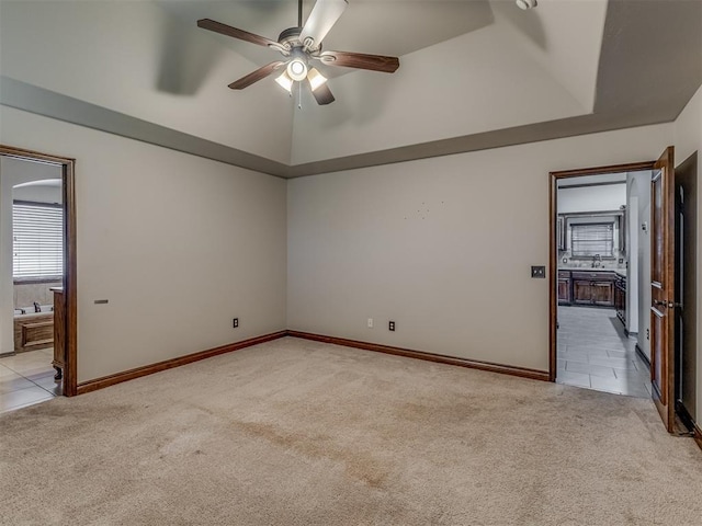 11749 SW 16th St, Yukon, OK 73099 - unfurnished room featuring light colored carpet, a ceiling fan, light tile patterned flooring, and a tray ceiling