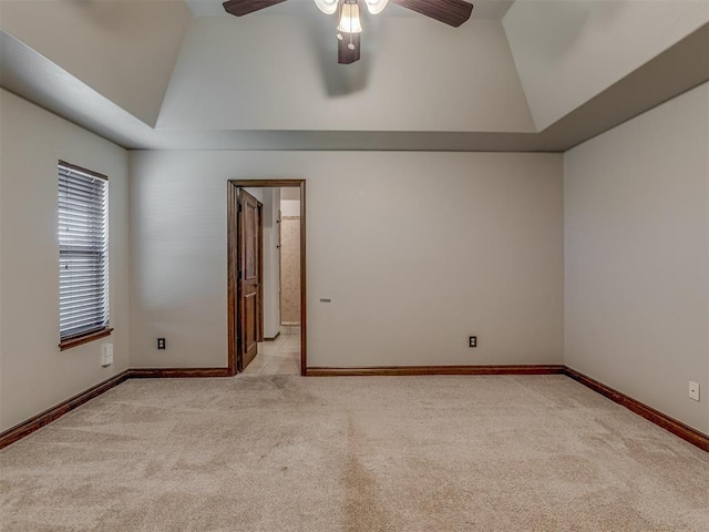 11749 SW 16th St, Yukon, OK 73099 - empty room featuring lofted ceiling, a ceiling fan, light colored carpet, and a tray ceiling