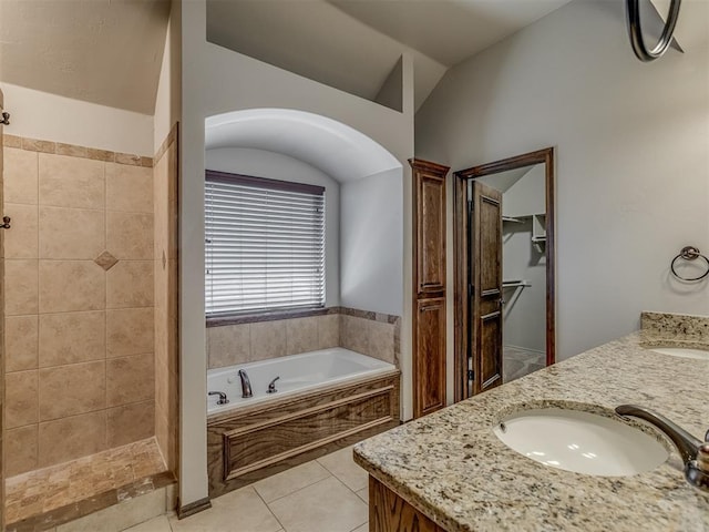 11749 SW 16th St, Yukon, OK 73099 - full bathroom with a garden tub, double vanity, lofted ceiling, tile patterned floors, and tiled shower