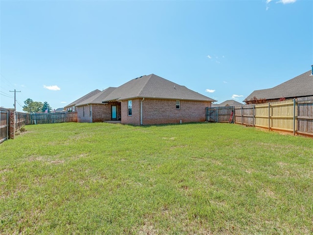 11749 SW 16th St, Yukon, OK 73099 - back of house with brick siding and a fenced backyard