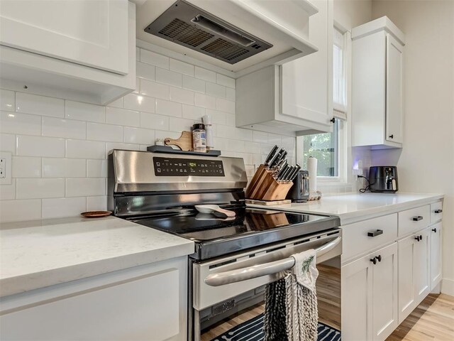 75 Lower Green Way, Carlton Landing, OK 74432 - kitchen featuring electric range, exhaust hood, white cabinetry, and light wood finished floors