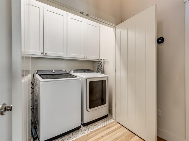 75 Lower Green Way, Carlton Landing, OK 74432 - laundry room with washer and dryer, cabinet space, and light wood-style flooring