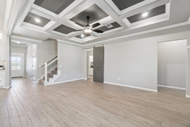 12904 SW 8th St, Yukon, OK 73099 - unfurnished living room featuring a barn door, coffered ceiling, ceiling fan, stairs, and light wood-style flooring