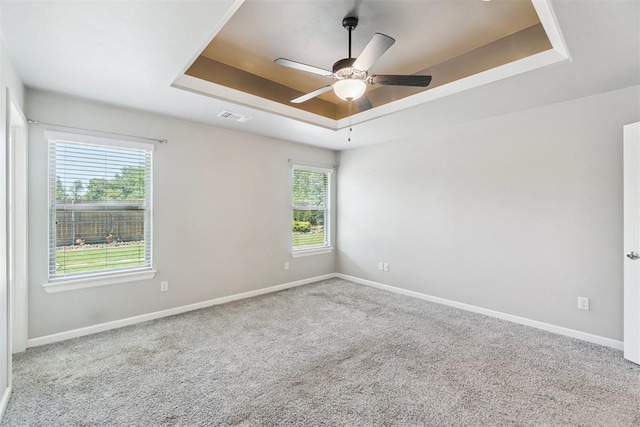 12904 SW 8th St, Yukon, OK 73099 - spare room featuring a raised ceiling, carpet flooring, and ceiling fan
