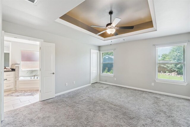 12904 SW 8th St, Yukon, OK 73099 - unfurnished room with a raised ceiling, a ceiling fan, and carpet floors