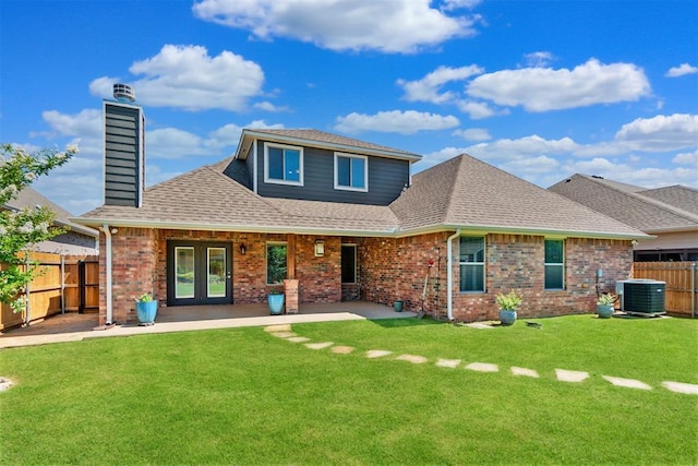 12904 SW 8th St, Yukon, OK 73099 - rear view of property featuring a fenced backyard, brick siding, roof with shingles, a patio area, and a chimney