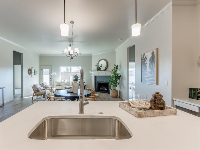11700 SW 15th Ter, Yukon, OK 73099 - kitchen featuring open floor plan, ornamental molding, pendant lighting, a chandelier, and light countertops