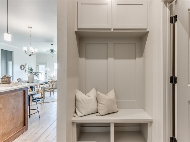 11700 SW 15th Ter, Yukon, OK 73099 - mudroom featuring light wood finished floors, ceiling fan, and a chandelier