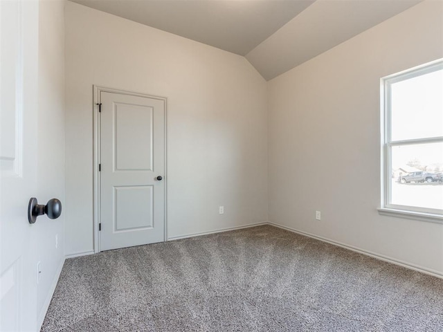 11700 SW 15th Ter, Yukon, OK 73099 - carpeted empty room featuring lofted ceiling and baseboards