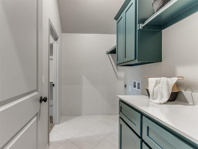 11700 SW 15th Ter, Yukon, OK 73099 - laundry area featuring washer hookup, cabinet space, hookup for an electric dryer, and light tile patterned flooring