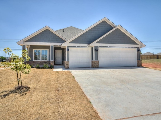 11700 SW 15th Ter, Yukon, OK 73099 - craftsman house featuring a garage, concrete driveway, brick siding, and covered porch