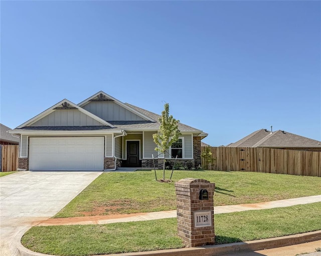 11728 SW 14th St, Yukon, OK 73099 - view of front facade featuring board and batten siding, concrete driveway, a garage, and brick siding