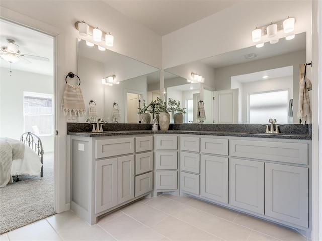 11728 SW 14th St, Yukon, OK 73099 - ensuite bathroom featuring double vanity, a ceiling fan, and tile patterned floors