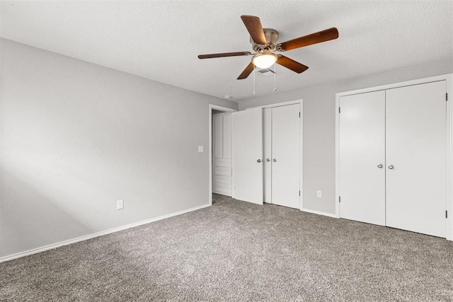 4800 SE 45th St, Oklahoma City, OK 73135 - unfurnished bedroom featuring two closets, carpet flooring, a textured ceiling, and ceiling fan