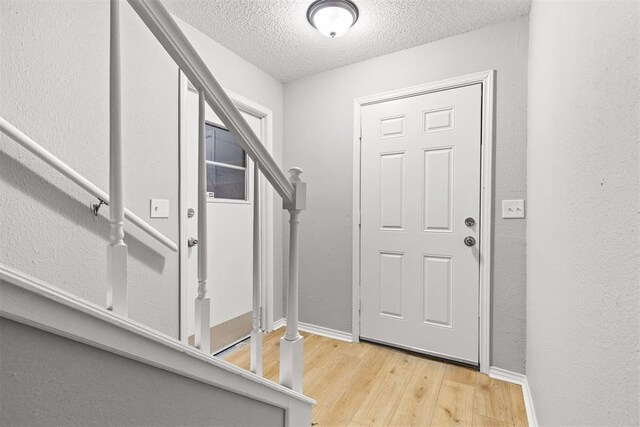 4800 SE 45th St, Oklahoma City, OK 73135 - entrance foyer with wood finished floors, a textured ceiling, and stairs