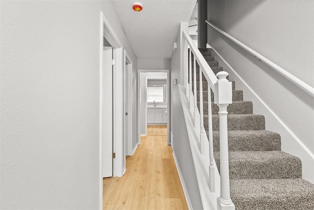 4800 SE 45th St, Oklahoma City, OK 73135 - stairs featuring wood finished floors and a textured ceiling