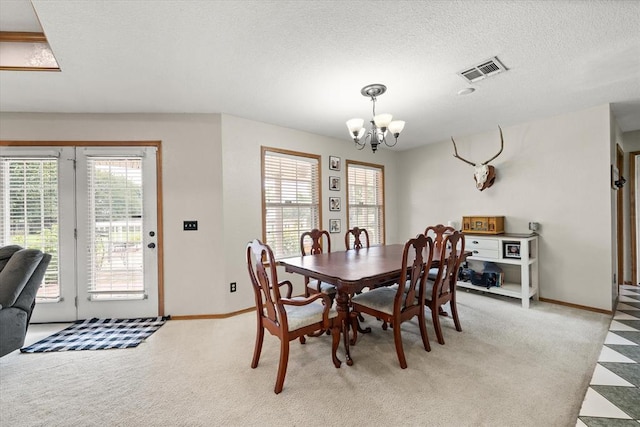 910796 S 3350th Rd, Wellston, OK 74881 - dining space with a chandelier, healthy amount of natural light, light colored carpet, and a textured ceiling