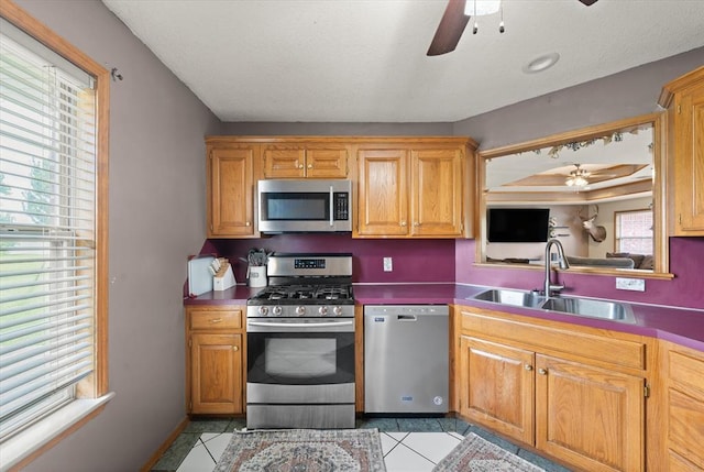 910796 S 3350th Rd, Wellston, OK 74881 - kitchen with appliances with stainless steel finishes, a ceiling fan, and light tile patterned floors