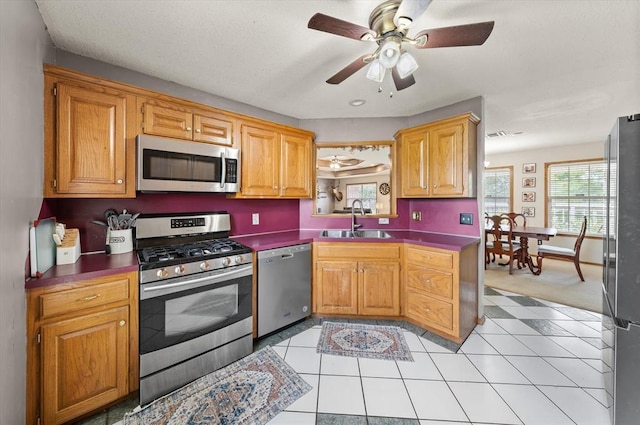 910796 S 3350th Rd, Wellston, OK 74881 - kitchen featuring appliances with stainless steel finishes, ceiling fan, light tile patterned flooring, dark countertops, and light colored carpet