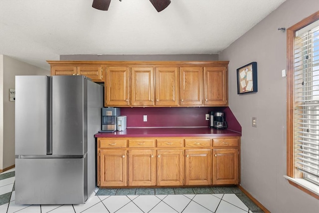 910796 S 3350th Rd, Wellston, OK 74881 - kitchen featuring freestanding refrigerator, ceiling fan, light tile patterned floors, and brown cabinetry