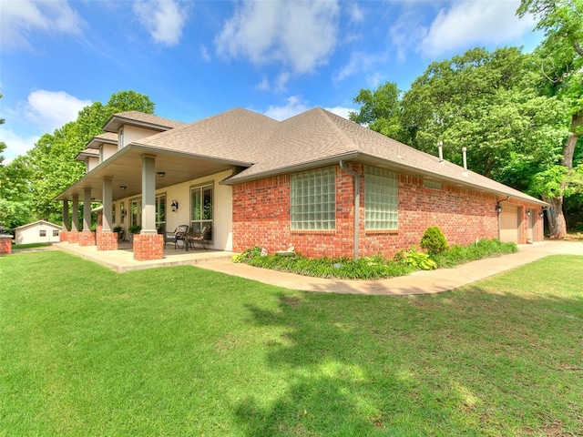 12905 S Mustang Rd, Mustang, OK 73064 - back of property with brick siding, a lawn, and a garage