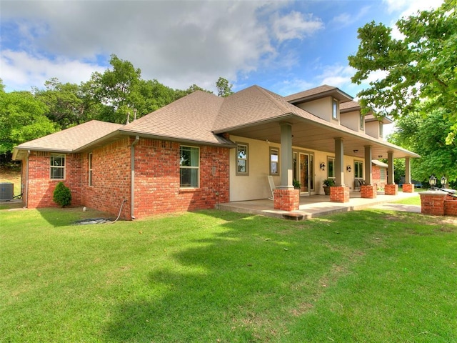 12905 S Mustang Rd, Mustang, OK 73064 - back of house featuring a lawn, a shingled roof, and brick siding
