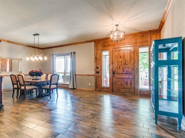 12905 S Mustang Rd, Mustang, OK 73064 - foyer with a chandelier, ornamental molding, hardwood / wood-style floors, wooden walls, and a textured ceiling