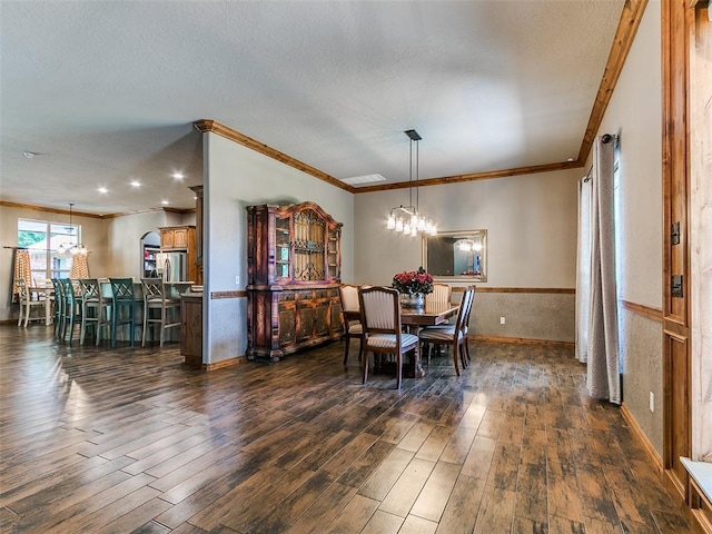 12905 S Mustang Rd, Mustang, OK 73064 - dining area featuring ornamental molding, dark wood-style flooring, a chandelier, a textured ceiling, and wainscoting