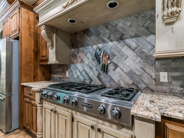 12905 S Mustang Rd, Mustang, OK 73064 - kitchen featuring appliances with stainless steel finishes, tasteful backsplash, and light stone counters