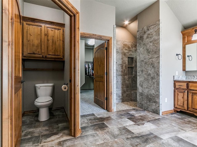 12905 S Mustang Rd, Mustang, OK 73064 - full bathroom featuring vanity, a walk in shower, stone finish floors, and a walk in closet