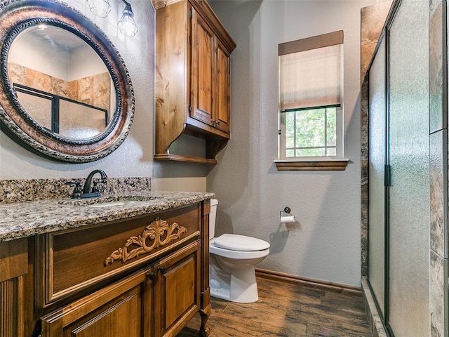 12905 S Mustang Rd, Mustang, OK 73064 - bathroom featuring wood finished floors, a stall shower, vanity, and a textured wall