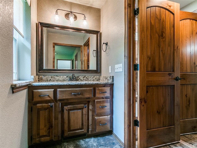 12905 S Mustang Rd, Mustang, OK 73064 - bathroom featuring a textured wall and vanity