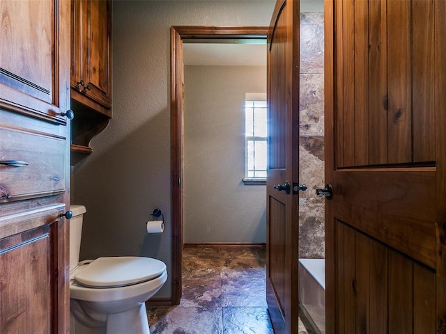 12905 S Mustang Rd, Mustang, OK 73064 - bathroom with toilet and baseboards