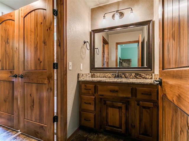 12905 S Mustang Rd, Mustang, OK 73064 - bathroom featuring a textured wall and vanity