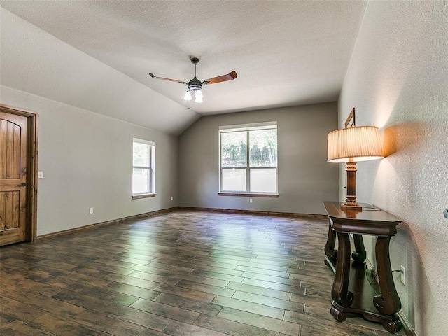 12905 S Mustang Rd, Mustang, OK 73064 - spare room with a ceiling fan, vaulted ceiling, dark wood finished floors, and a textured wall
