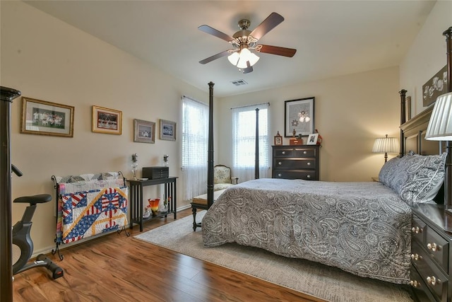 2221 NW 158th St, Edmond, OK 73013 - bedroom with wood finished floors and ceiling fan