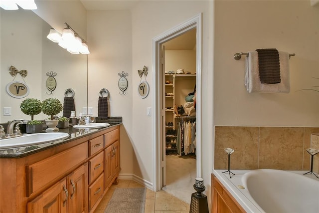 2221 NW 158th St, Edmond, OK 73013 - full bath with double vanity, tile patterned floors, a bath, and a spacious closet