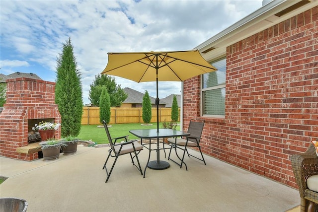 2221 NW 158th St, Edmond, OK 73013 - view of patio / terrace with an outdoor brick fireplace and outdoor dining space