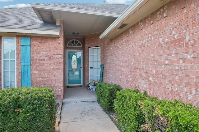 4605 Mackenzie Dr, Moore, OK 73160 - entrance to property with a shingled roof and brick siding