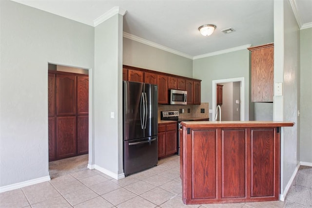 4605 Mackenzie Dr, Moore, OK 73160 - kitchen featuring stainless steel appliances, crown molding, a peninsula, tasteful backsplash, and light tile patterned flooring