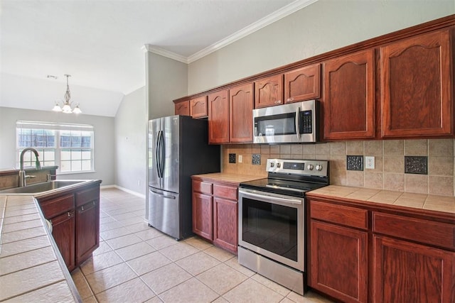 4605 Mackenzie Dr, Moore, OK 73160 - kitchen with appliances with stainless steel finishes, tile counters, a chandelier, decorative backsplash, and light tile patterned flooring