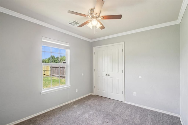 4605 Mackenzie Dr, Moore, OK 73160 - unfurnished bedroom with carpet flooring, crown molding, a closet, and a ceiling fan