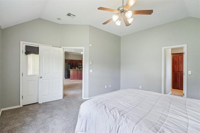 4605 Mackenzie Dr, Moore, OK 73160 - bedroom featuring vaulted ceiling, carpet floors, freestanding refrigerator, and a ceiling fan