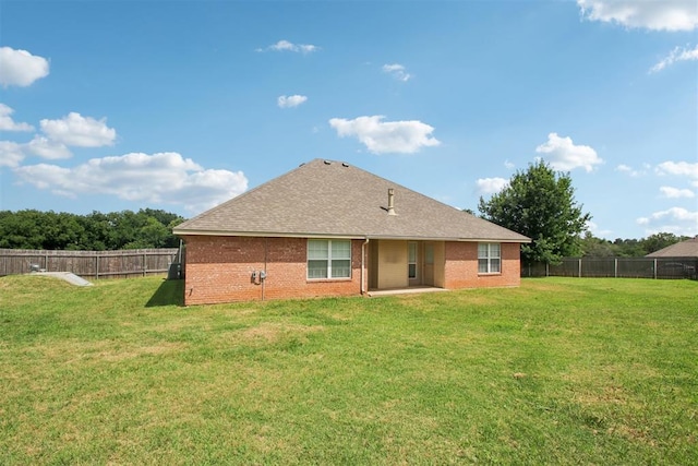 4605 Mackenzie Dr, Moore, OK 73160 - rear view of house featuring a fenced backyard, brick siding, and roof with shingles