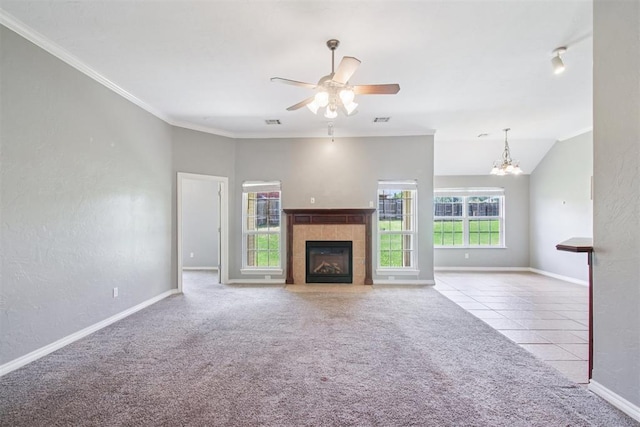 4605 Mackenzie Dr, Moore, OK 73160 - unfurnished living room featuring a tiled fireplace, ceiling fan, carpet flooring, a chandelier, and tile patterned flooring