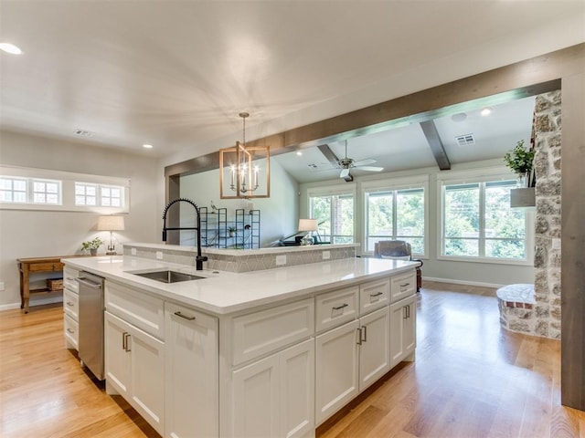 3508 Pavilion Pl, Edmond, OK 73034 - kitchen featuring plenty of natural light, white cabinets, light wood finished floors, beamed ceiling, and recessed lighting