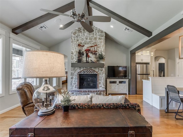 3508 Pavilion Pl, Edmond, OK 73034 - living area with ceiling fan, wood finished floors, arched walkways, and a fireplace