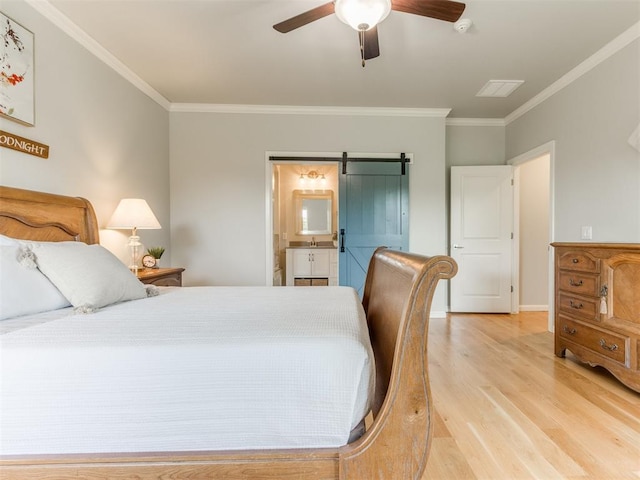 3508 Pavilion Pl, Edmond, OK 73034 - bedroom with light wood-style floors, ornamental molding, a barn door, connected bathroom, and ceiling fan