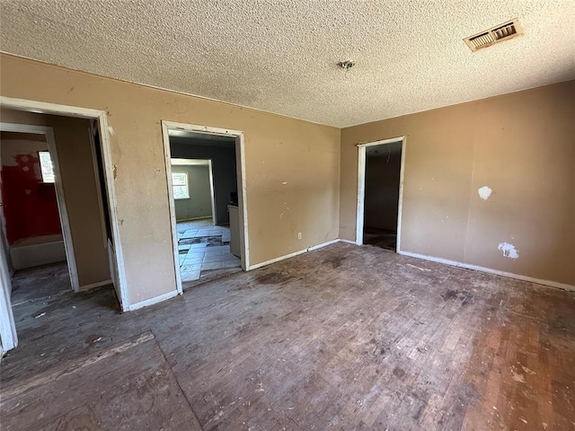 2918 N Prospect Ave, Oklahoma City, OK 73111 - unfurnished bedroom with a textured ceiling and wood finished floors