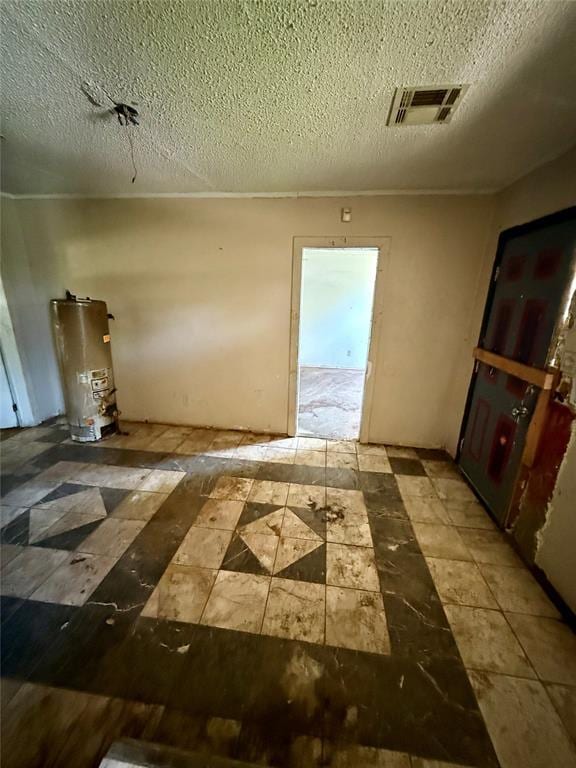 2918 N Prospect Ave, Oklahoma City, OK 73111 - empty room with gas water heater and a textured ceiling